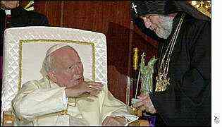Pope John Paul II receives a gift from Catholicos Karekin II